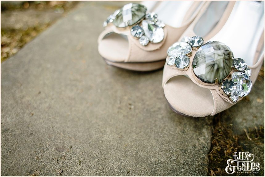 Wedding shoes in pach with grey stone detail photographed at an angle