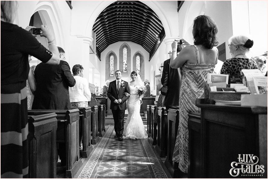 Bride and groom walk down the aisle in UK church 