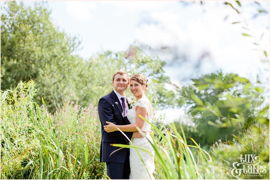 UK Wedding photography of a relaxed and natural bride and groom smiling taken from upwards angle