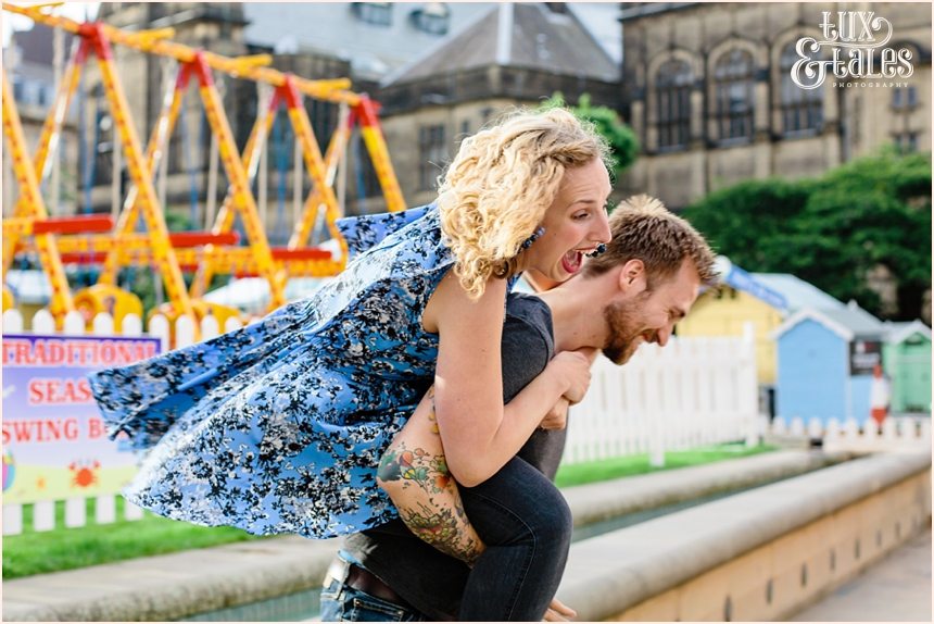 Girl laughs loudly in funn protrait giving piggyback ride at Sheffield summer bach 