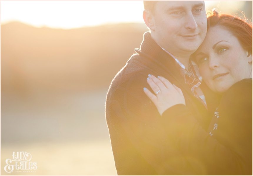 Gorgeous couple snuggle in the sunset at Scarborough north beach