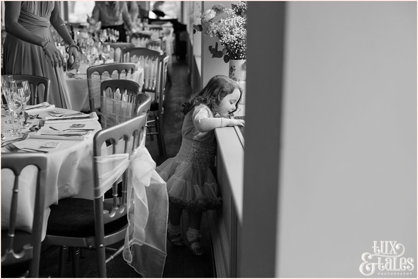 Little girl looks out the window at wedding at the Alma Inn