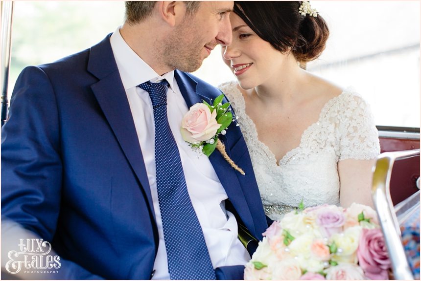 Brdie and groom snuggle on London bus