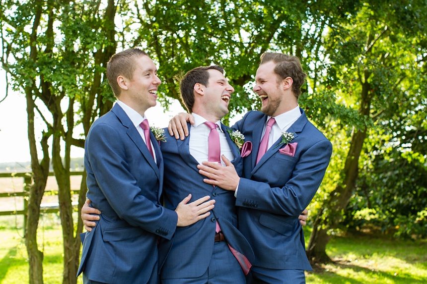 Groom & groomsmen having a big cuddle Barmbyfield Barn Wedding Photography