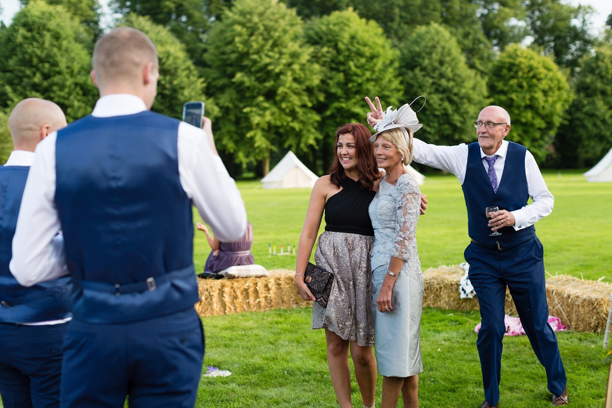 Wedding guests being silly photobomb bunny ears