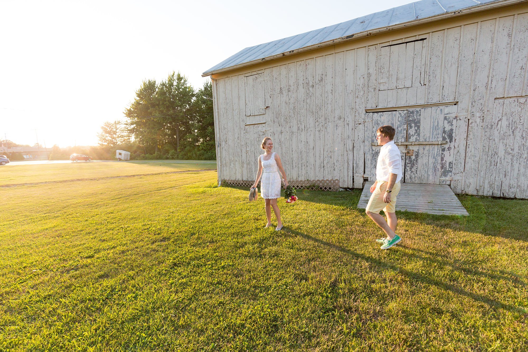 Brdie and groom walk in sunset 