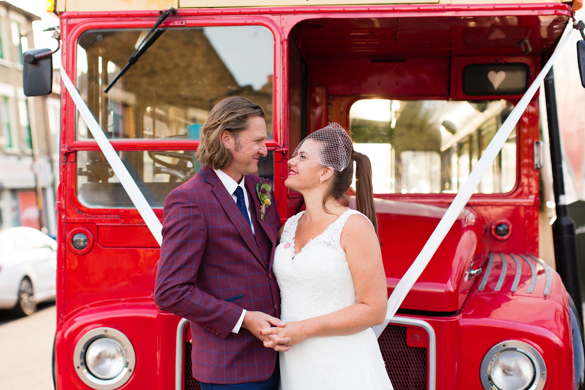 Bride and groom portrait in front of London bus