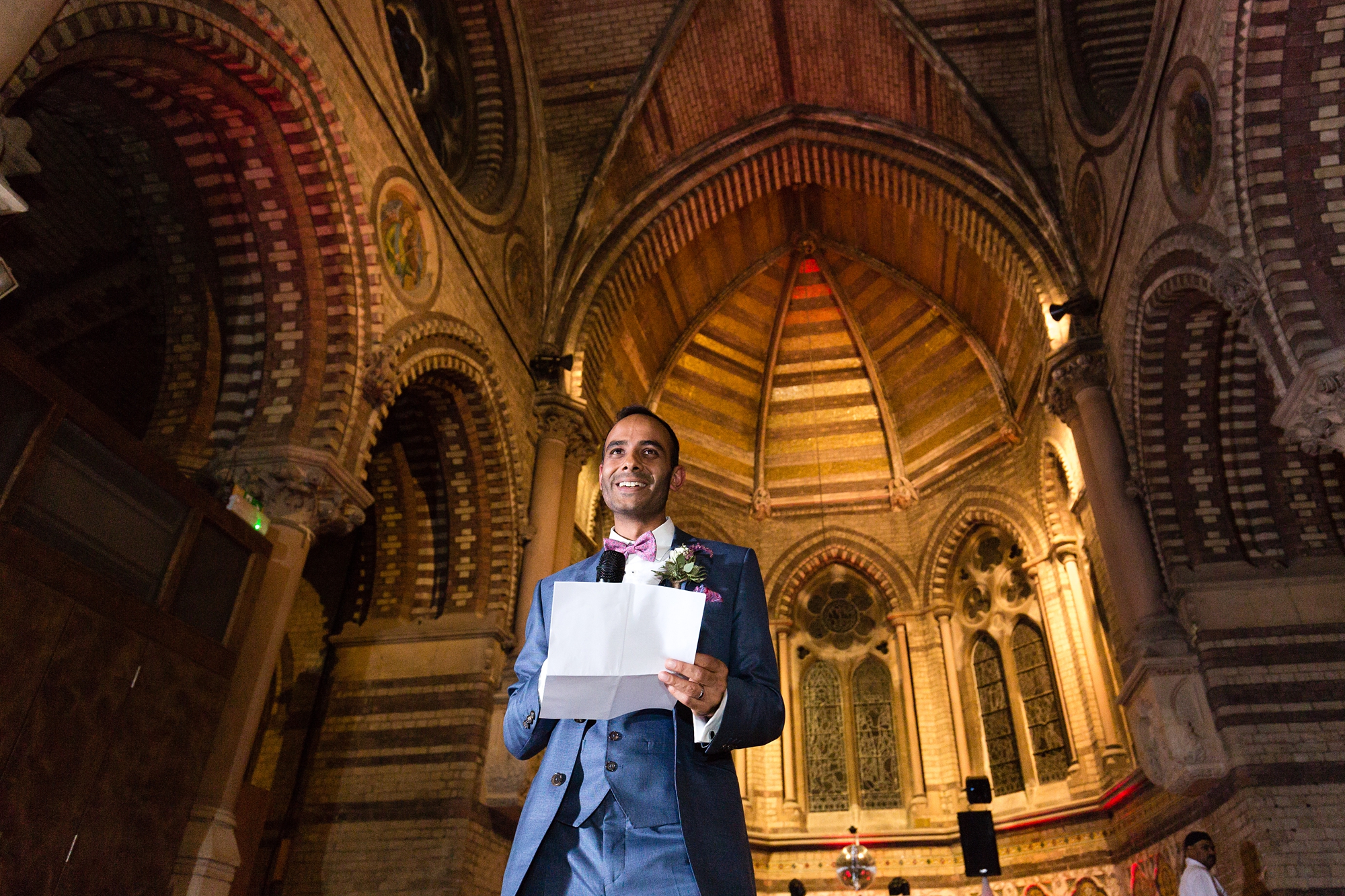 Groom gives speech with church background St Stephens Hampstead Heath Wedding Venue