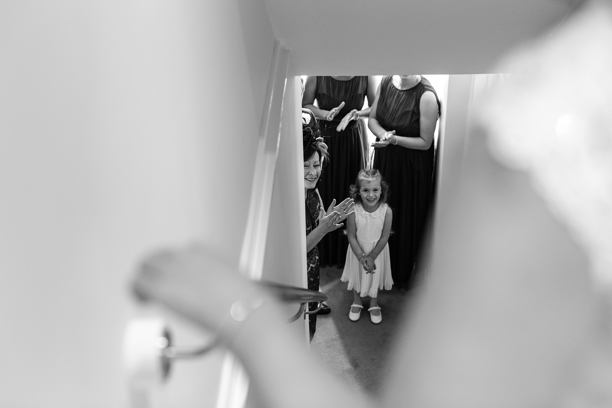 Family looking on as bride walks down the stairs Bell Hall Wedding Photography