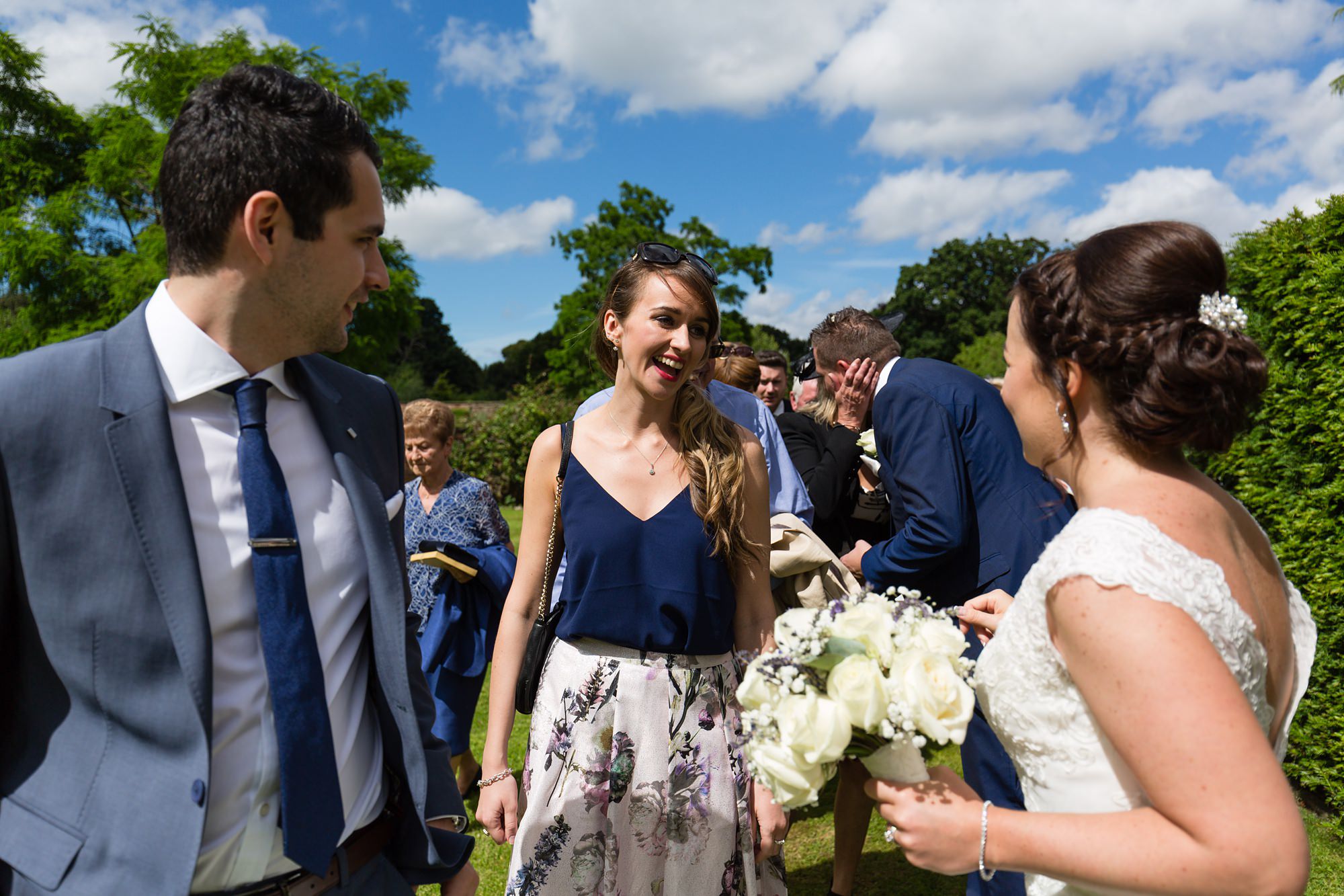 Bell Hall Wedding Photography guests hugging and saying hello to the couple. 