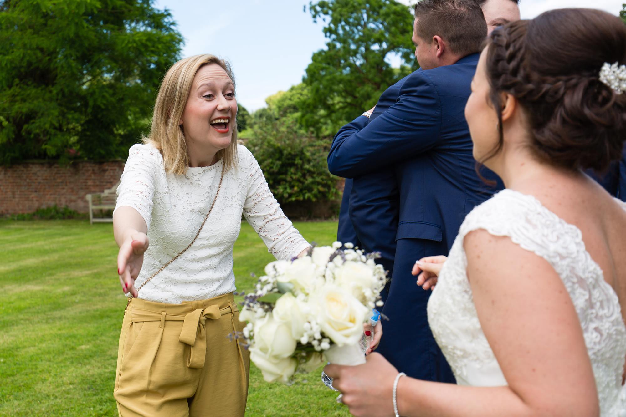 Bell Hall Wedding Photography guests hugging and saying hello to the couple big smile