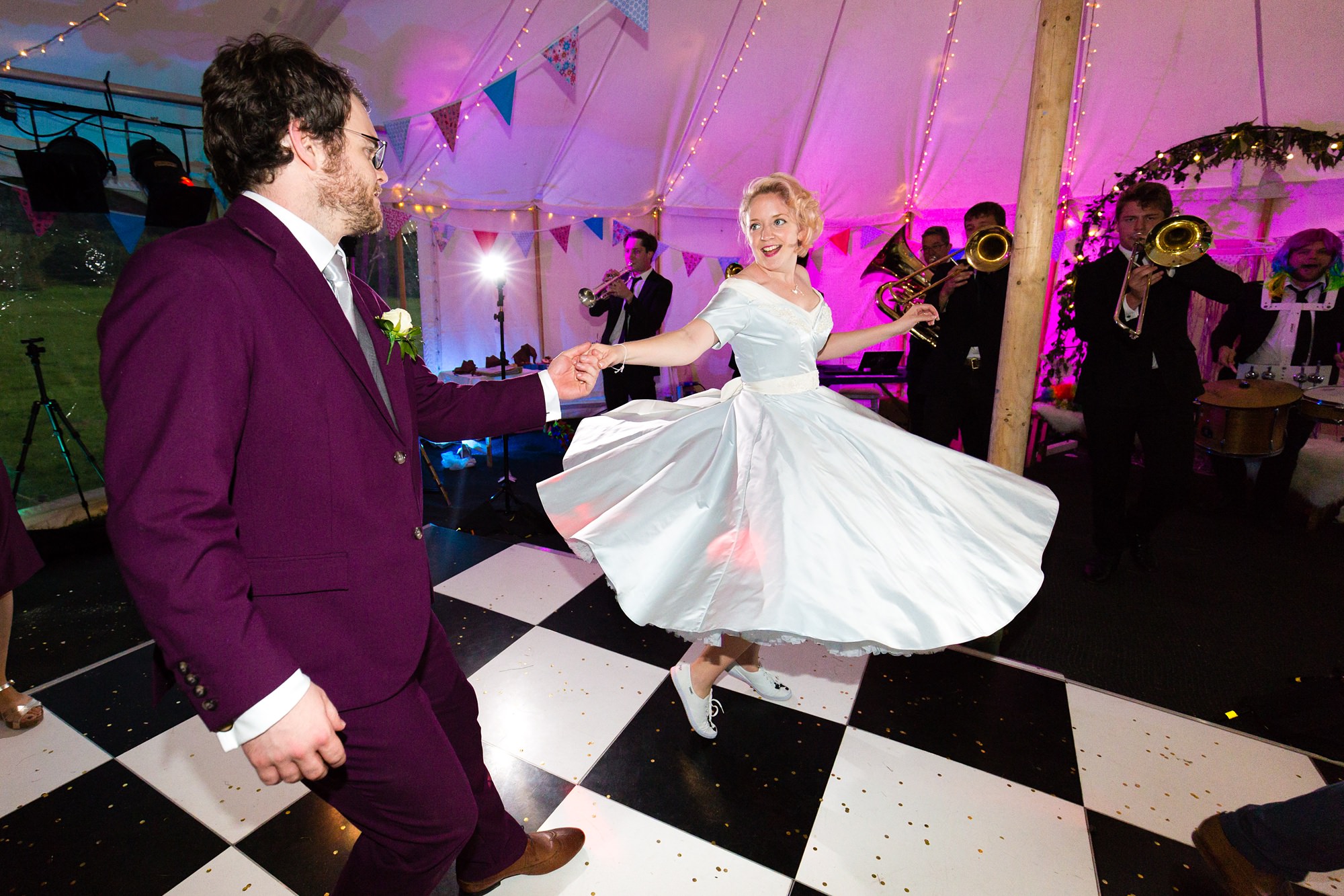Bride and groom dance on black and white chequerboard dance floor