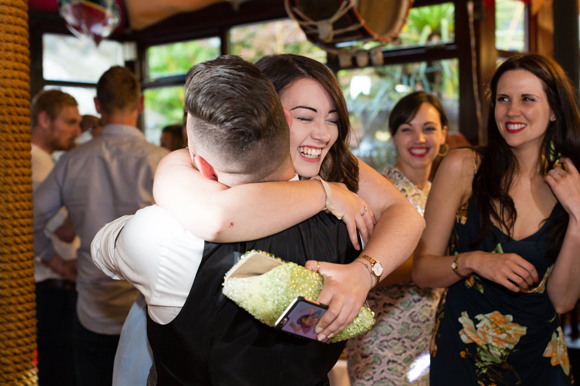 Guest hugging groom at Crab & Lobster wedding