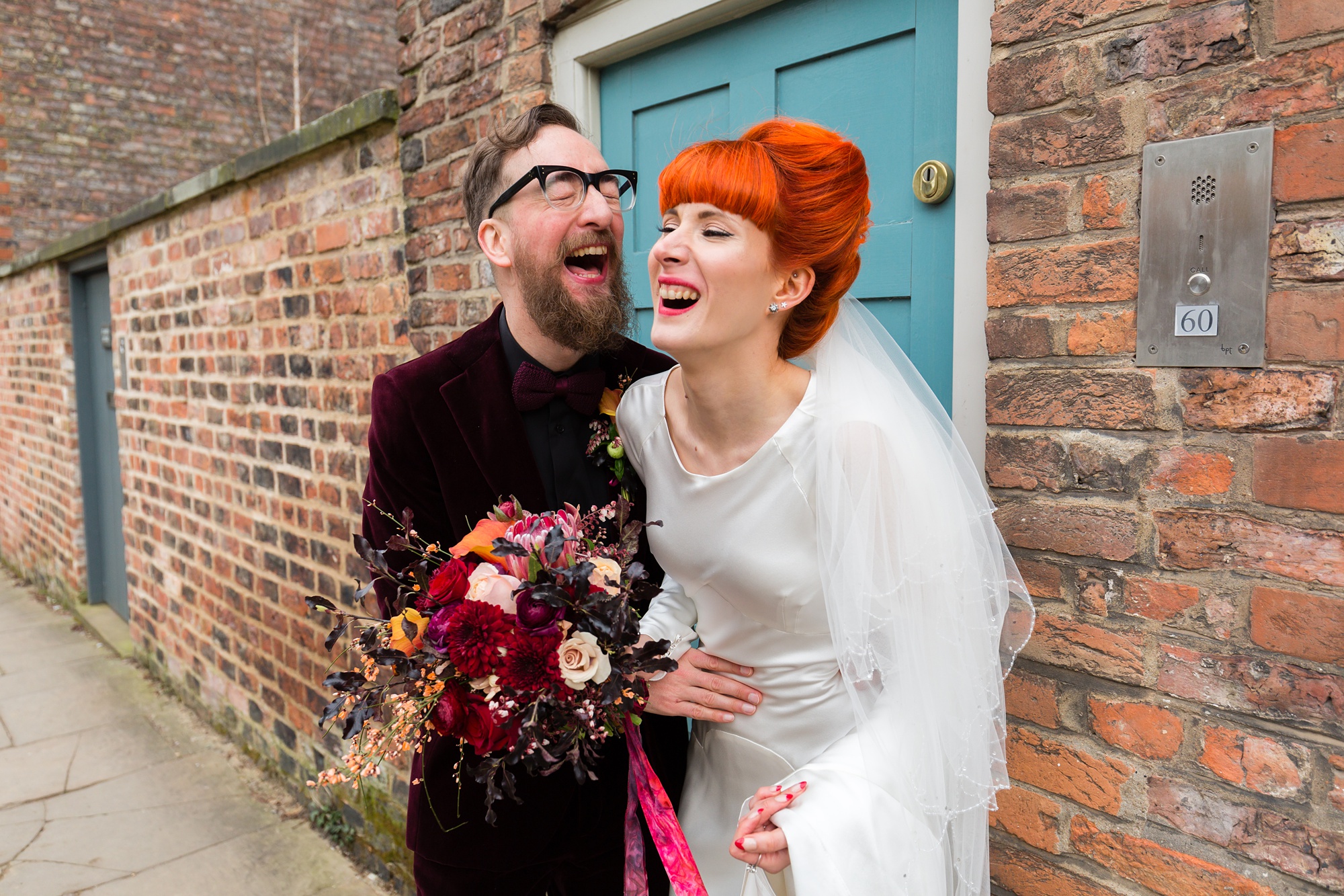 Wedding couple laughing ouside of Aqua door in York City Centre