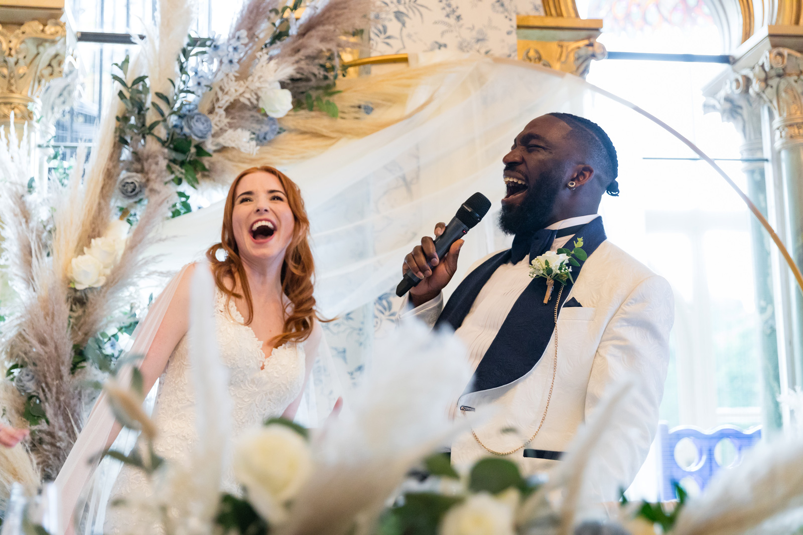 Groom sings into microphone at Rushpool Hall wedding