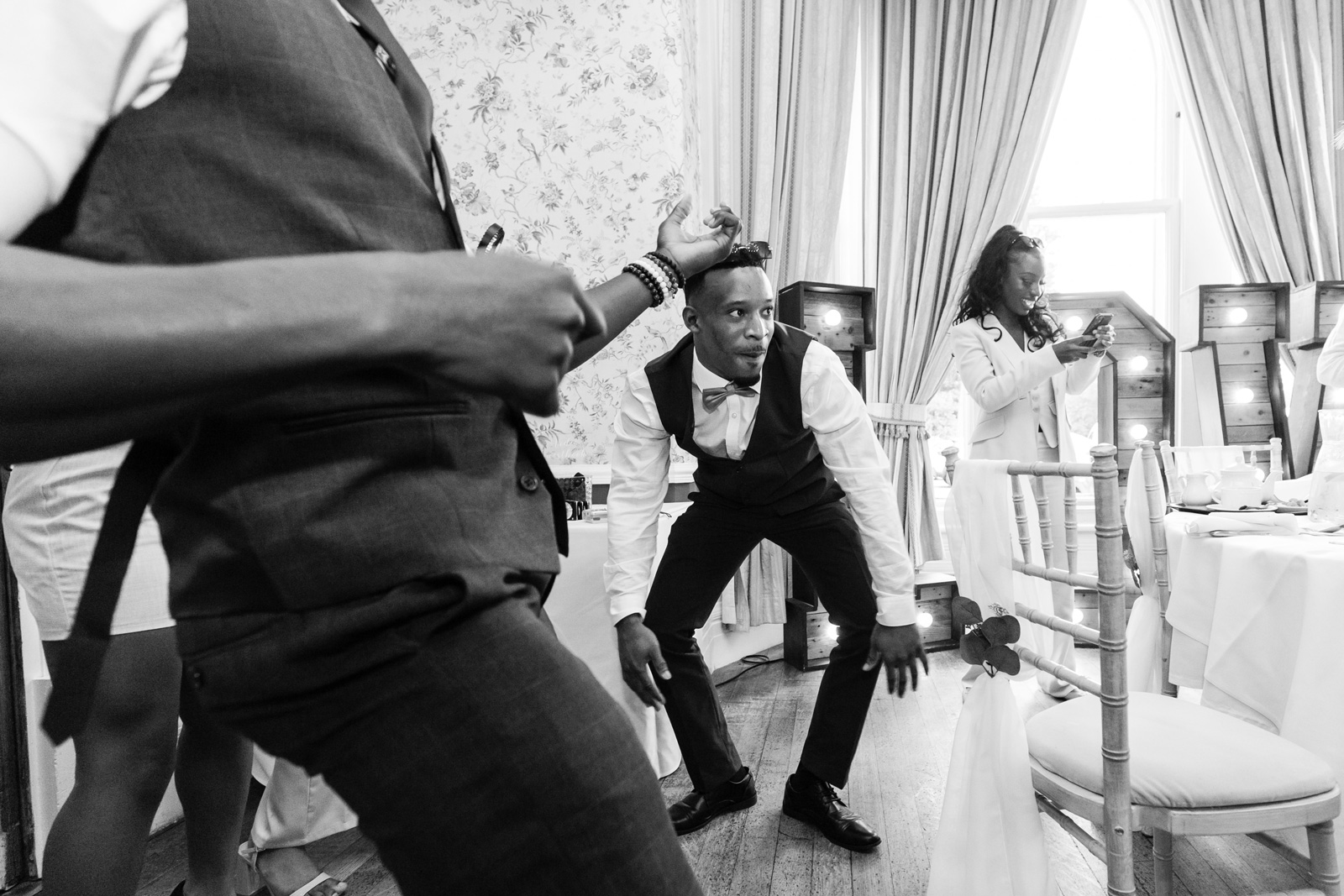 Guests dance along with winging waiters at Rushpool Hall wedding