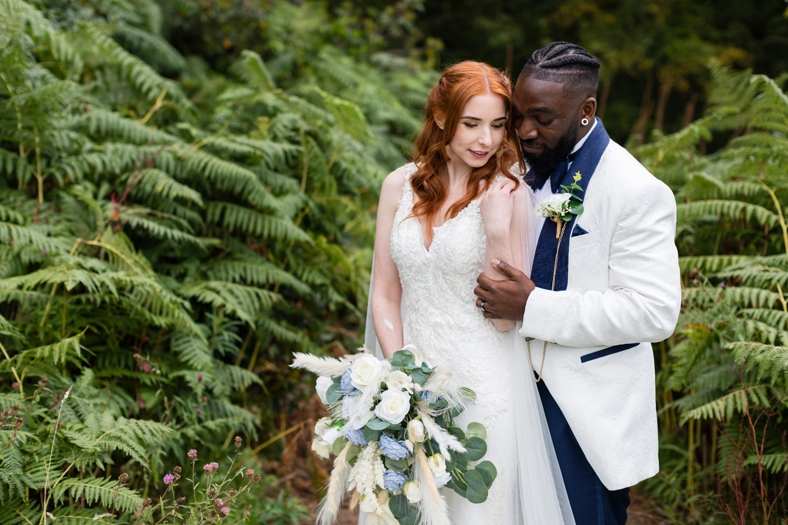 Bride and groom portrait taken in the brakcen at the edge of Rushpool Hall.