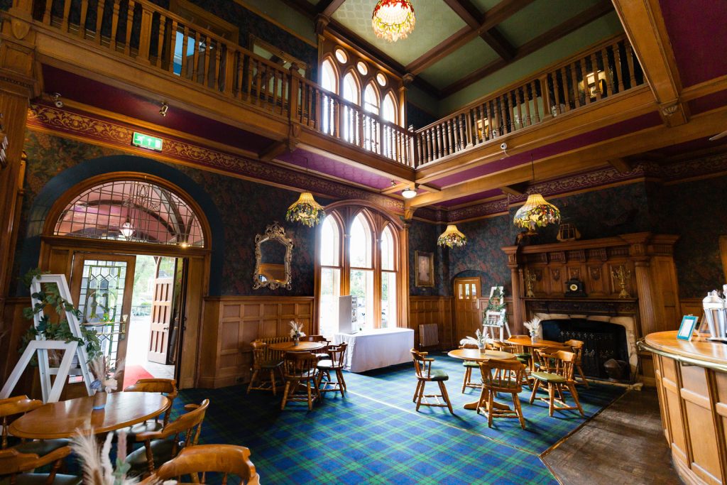 Main bar area with tartan carpet and wood details at Rushpool Hall