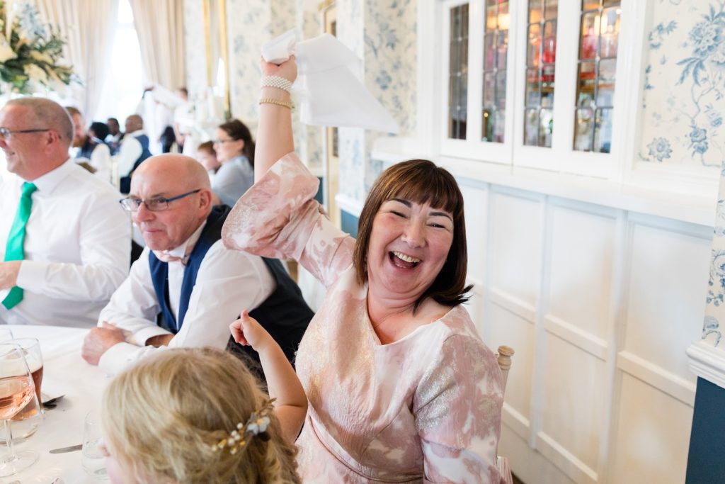 Guest swings napkin during rushpool hall wedding entertainment