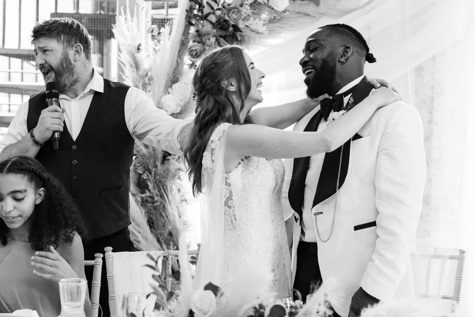 Bride and groom sing to each other and smile during winging waiter at Rushpool Hall wedding